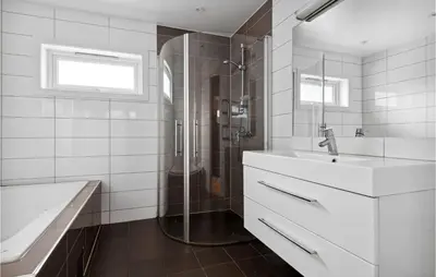 a white bathroom with a sink and a shower at 3 Bedroom Awesome Apartment In Nesttun in Bergen
