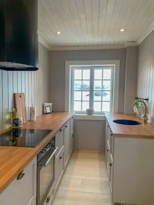 a large kitchen with a counter and a window at Villa Gulstua in Røros
