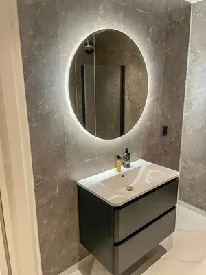 a bathroom with a sink and a mirror on the wall at Villa Gulstua in Røros