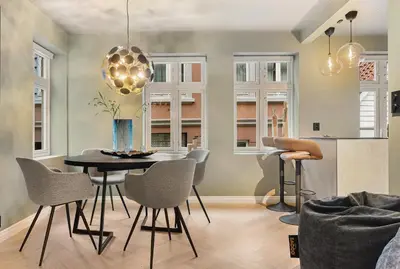 a kitchen and dining room with a table and chairs at Bryggen Living in Bergen