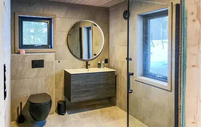 a bathroom with a sink and a mirror at Nice Home In Edland With Wifi