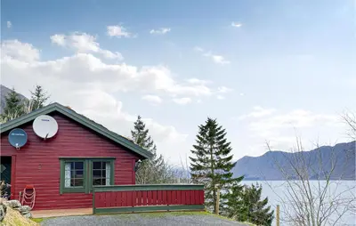 a red house with a satellite on top of it at 2 Bedroom Cozy Home In Lauvstad in Lauvstad