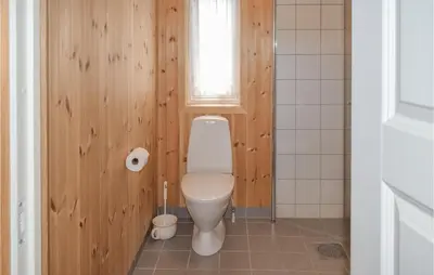 a bathroom with a toilet and a window at Gorgeous Home In Noresund With Wifi in Noresund