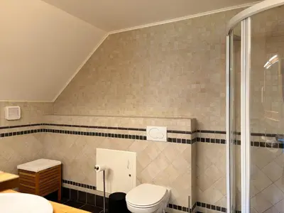a bathroom with a toilet and a shower at Flåm Holiday Home in Flåm