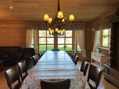 a large dining room with a long table and chairs at Flåm Holiday Home in Flåm