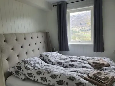 a bed in a bedroom with a window at Molden 1 - med Jacuzzi! in Luster