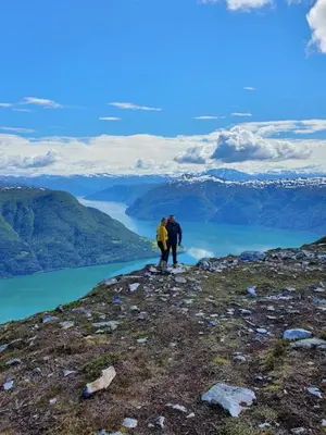 two people standing on top of a mountain overlooking a lake at Molden 1 - med Jacuzzi! in Luster