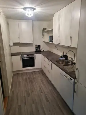 a kitchen with white cabinets and a sink at Fjærland Våteviksvegen 17 in Bøyum