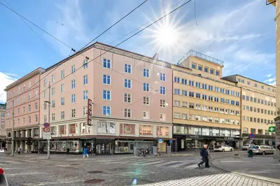 a large pink building on a city street at 2 min to Bryggen - Rooftop - Office with 49