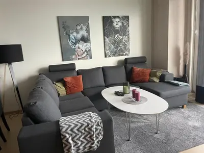 a living room with a couch and a table at MJOS TOWER Suite - Lovely lake view in Brumunddalen