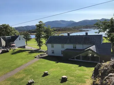 an aerial view of a house with a large yard at Storlauvøya The Atlantic Ocean Road in Karvåg