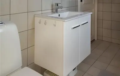 a white bathroom with a sink and a toilet at Nice Home In Hemsedal With Sauna in Hemsedal