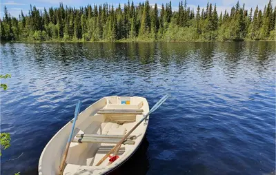 a boat sitting in the water on a lake at Nice Home In Hemsedal With Sauna in Hemsedal