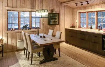 a dining room with a wooden table and chairs at 3 Bedroom Cozy Home In Røros in Røros