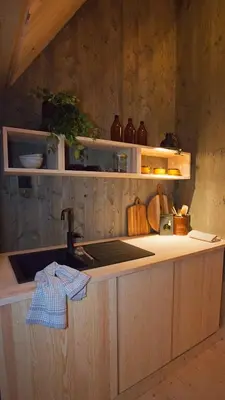 a kitchen with a sink and a counter top at Fuglekassehytta in Sparbu