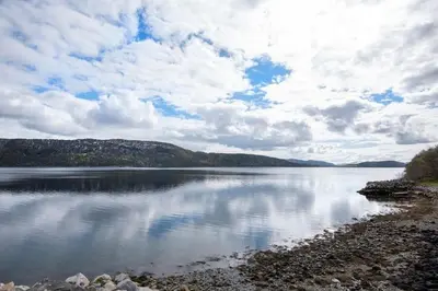 a large body of water with a cloudy sky at Helt ny rorbu på Slyngstad i Ålesund Kommune in Ålesund
