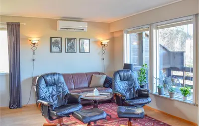a living room with a couch and two chairs and a table at Stunning Home In Skånevik With Kitchen in Skånevik