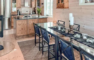 a kitchen with a long table with chairs and a sink at Nice Home In Veggli With Wifi in Veggli