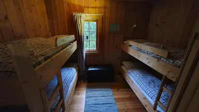 a room with two bunk beds in a cabin at Cozy log cabin at beautiful Nystølsfjellet in Gol