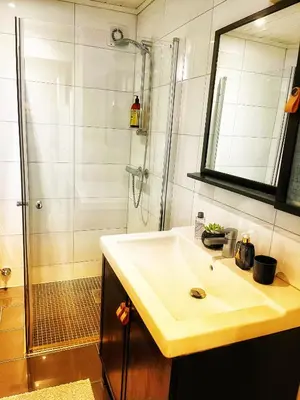 a bathroom with a sink and a shower at Light home apartment Alesund with free parking in Ålesund