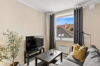 a living room with a couch and a window at Forenom Serviced Apartments Bergen Skottegaten in Bergen