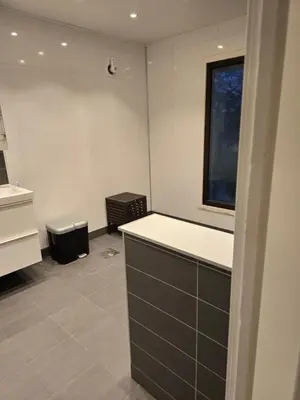 a bathroom with a sink and a toilet in it at Florvåg -flott utsikt mot byen in Florvåg