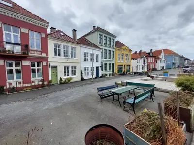 a group of buildings with benches in a street at Bergen city center apartment in Bergen