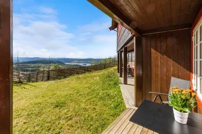 a house with a balcony with a view of a field at Bjødnabakkens innbydende in Beitostøl