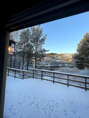 a view of a snow covered porch with a fence at A cottage by the forest with a sea view ! in Søfstad