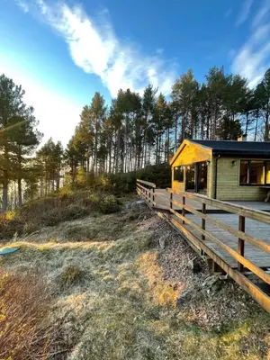 a cabin in the woods with a wooden fence at A cottage by the forest with a sea view ! in Søfstad