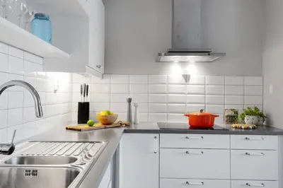 a white kitchen with white cabinets and a sink at Stor og moderne leilighet i Indre Arna Bergen GRATIS PARKERING!! in Bergen