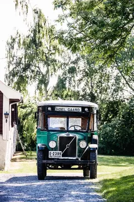 an old green truck parked on the side of a road at Hoel Gård - Herregården ved Mjøsa in Nes i Ådal