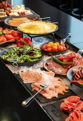 a buffet with many different types of food on at Thon Hotel Ålesund in Ålesund