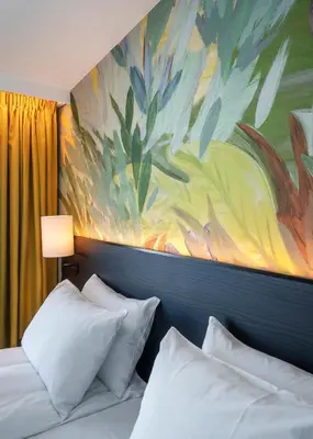 a bedroom with two beds and a painting on the wall at Thon Hotel Ålesund in Ålesund