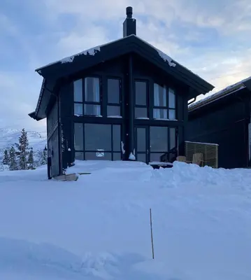 a black building with snow in front of it at Gaustablikk Sportshytte midt i naturen in Rjukan