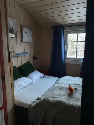 a small room with two beds and a window at Cabin in the Mountain, with Solar Energy in Slidre