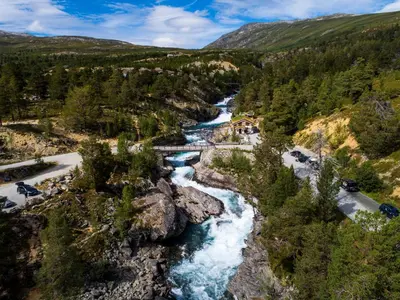 an aerial view of a river with a bridge at Billingen Seterpensjonat in Skjåk