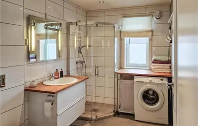 a bathroom with a sink and a washing machine at Gorgeous Home In Revsnes With Wifi in Refsnes