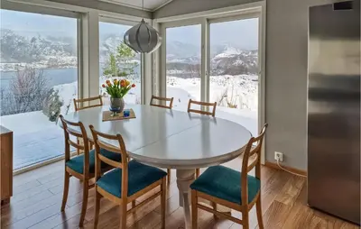 a kitchen with a table and chairs and a large window at Gorgeous Home In Revsnes With Wifi in Refsnes