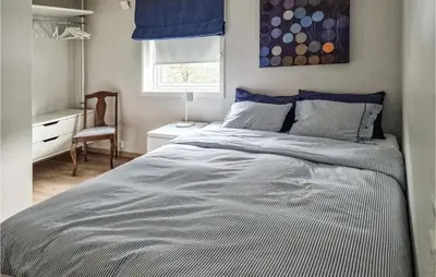 a bedroom with a bed and a desk and a window at Gorgeous Home In Revsnes With Wifi in Refsnes