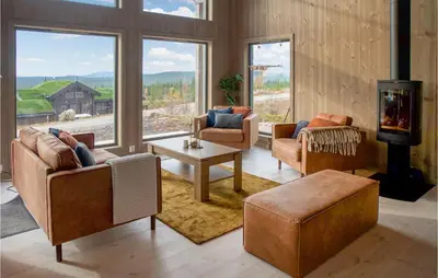a living room with couches and a fireplace at 4 Bedroom Lovely Home In Østby in Østby