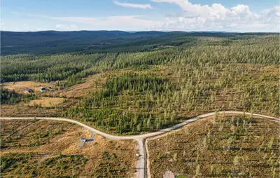 an aerial view of a road in a forest at 4 Bedroom Lovely Home In Østby in Østby