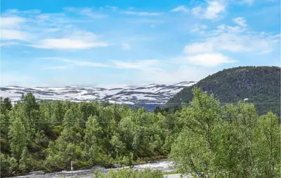 a view of snow covered mountains and trees at Hovden Alpin Apartments in Hovden