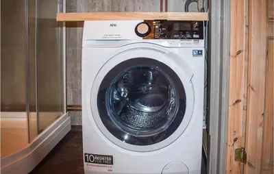 a white washing machine in a room at Cozy Home In Tuddal With Kitchen in Tuddal
