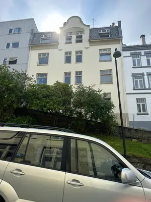a car parked in front of a large building at Ålesund City Center - Modern 80-m2 flat with 3 bedrooms in Ålesund