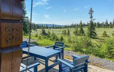 two blue benches sitting on a porch swing at Beautiful Home In Sjusjoen in Sjusjøen