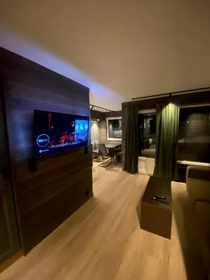 a living room with a large flat screen tv at Brobygget Mølla 101 in Kyrkjebøen