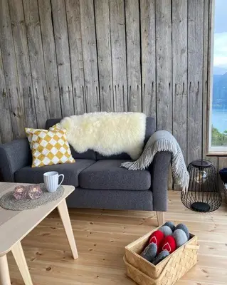 a living room with a couch and a table at Raaum Gard, hytte 2 in Hafslo