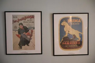 two framed posters of a woman and a polar bear on a wall at Dinbnb Apartments I Charming 3-Bedroom in the Heart of the City in Bergen