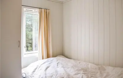 a bedroom with a bed and a window at Stunning Home In Førde I Hordaland in Lier